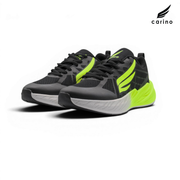A pair of Carino athletic sneakers in black and gray with bright neon yellow-green accents, shown on a clean white background with the Carino brand logo in the top right corner.